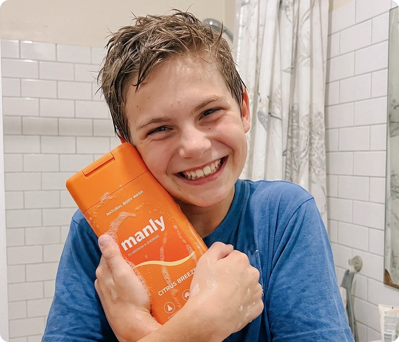 Teen grabbing his Manly natural body wash in the shower
